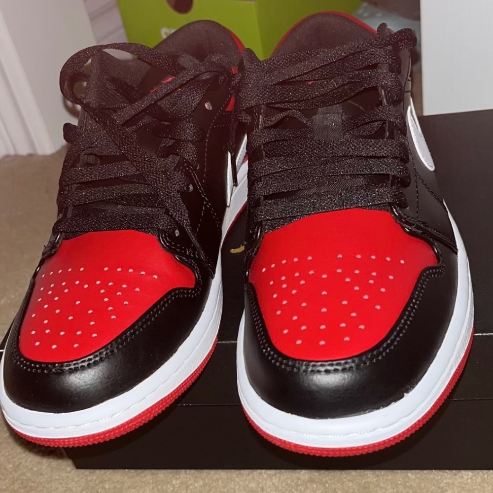 Black and red Nike Jordon's 1 low